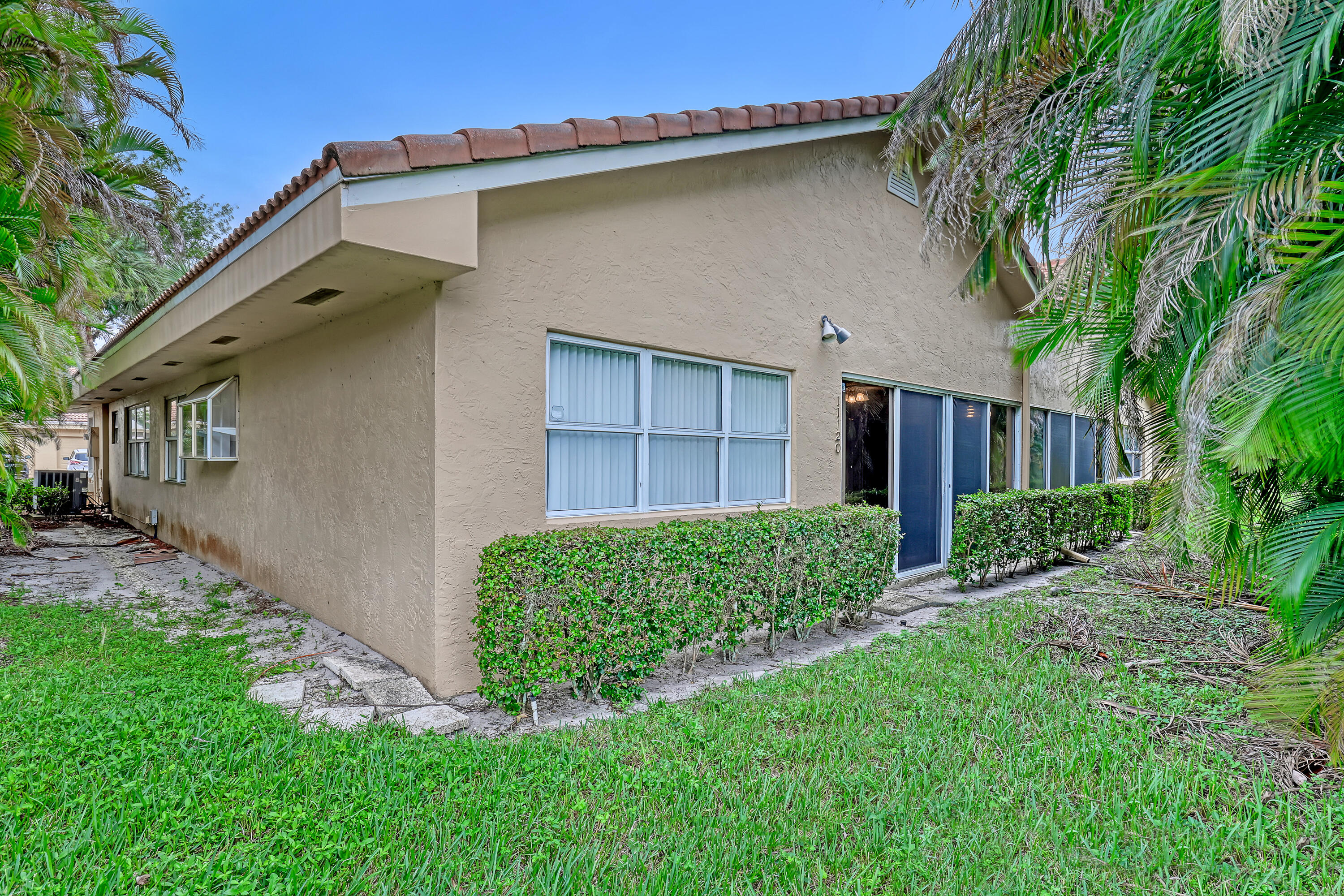 11120 Rios Road Boca Raton, FL 33498 - Photo 33 of 36 a view of a house with a large window and a yard