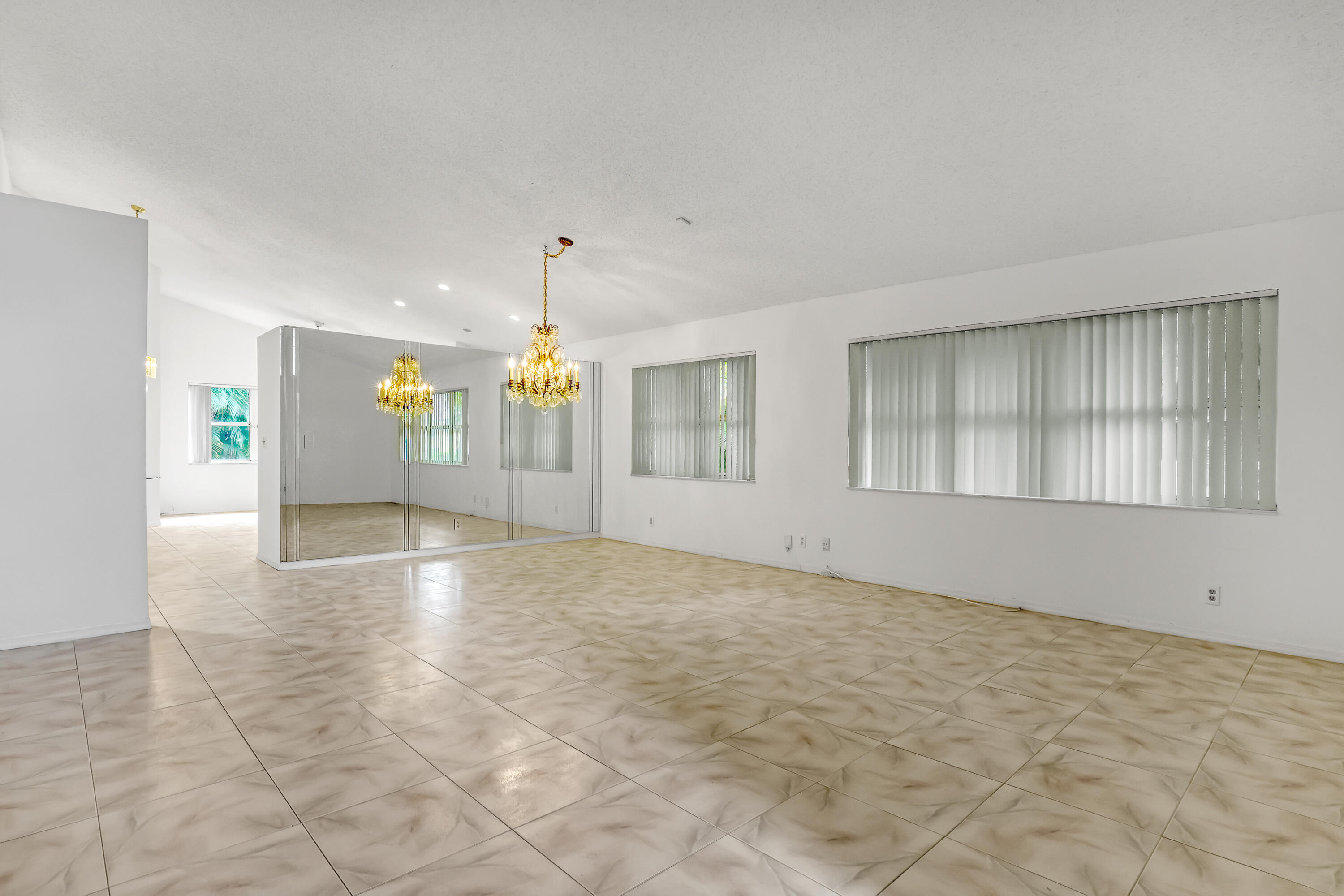 11120 Rios Road Boca Raton, FL 33498 - Photo 6 of 36 a view of an empty room with kitchen and window