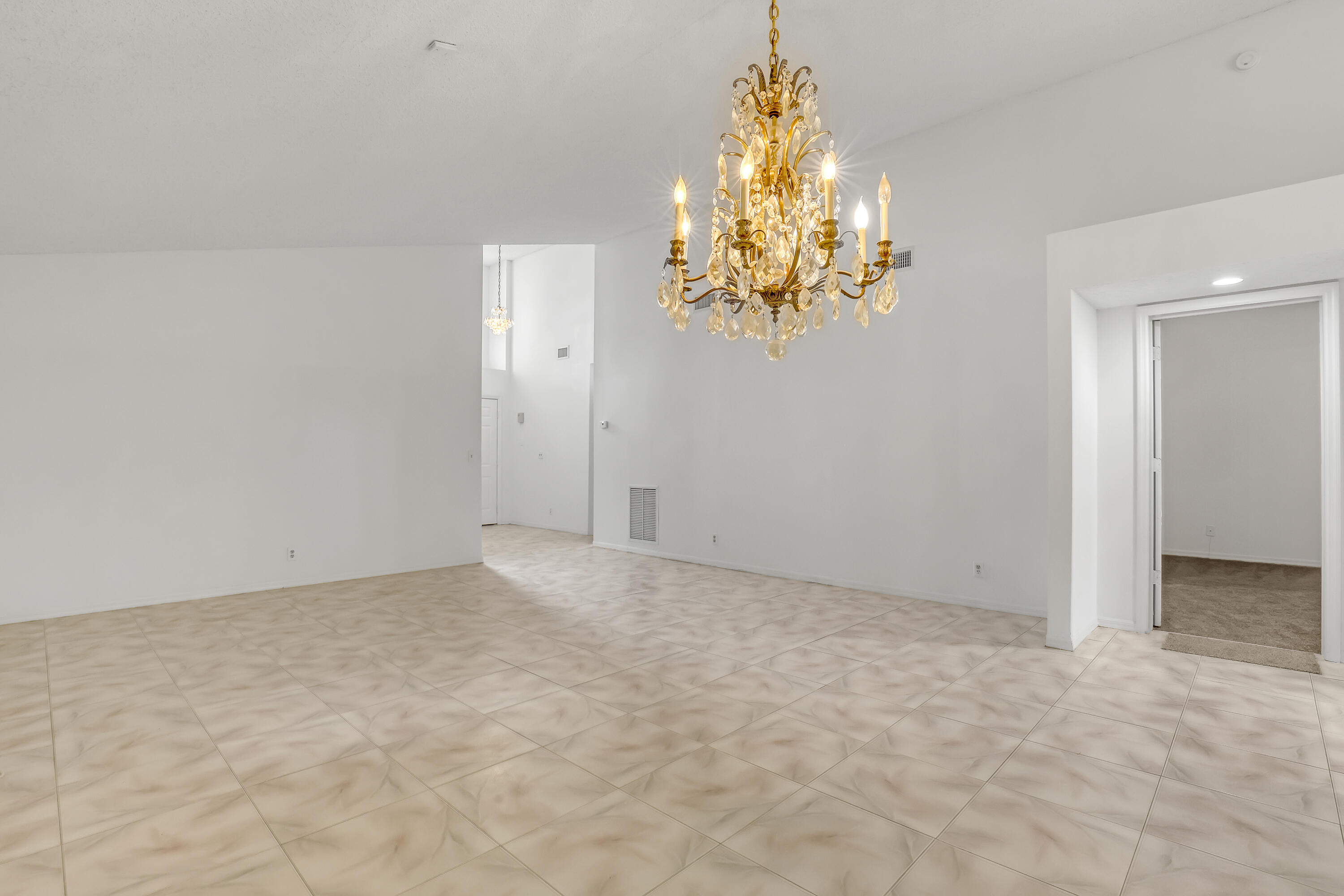 11120 Rios Road Boca Raton, FL 33498 - Photo 8 of 36 a view of an empty room with a chandelier