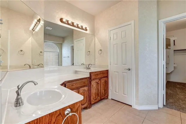 a spacious bathroom with a sink double vanity and a mirror
