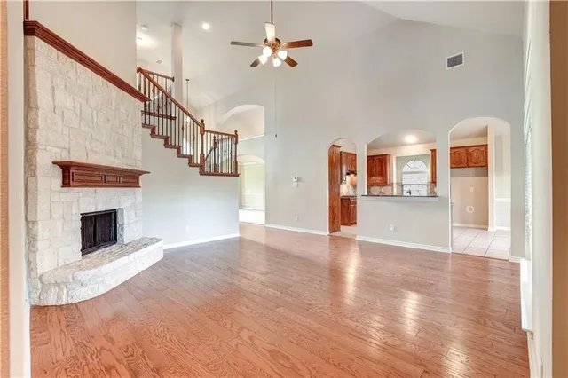 a view of empty room with wooden floor and fireplace