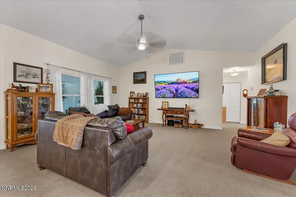 a kitchen with stainless steel appliances granite countertop a stove top oven a sink a dining table and chairs