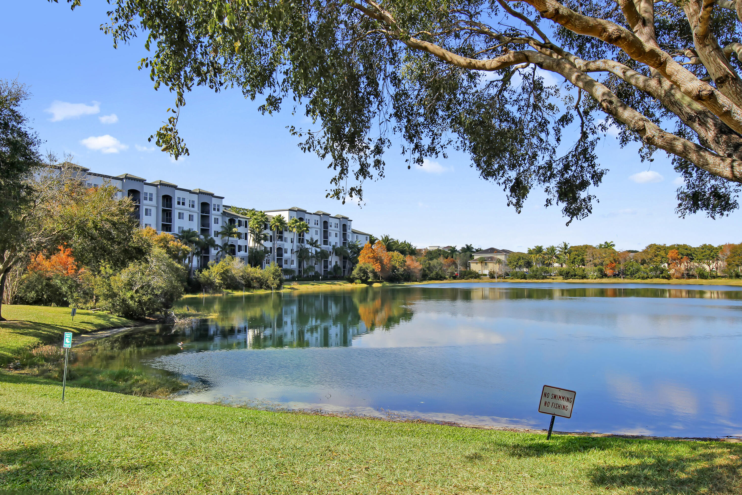 1690 Renaissance Commons Boulevard Boynton Beach, FL 33426 - Photo 19 of 22 a view of a lake with a house in the background