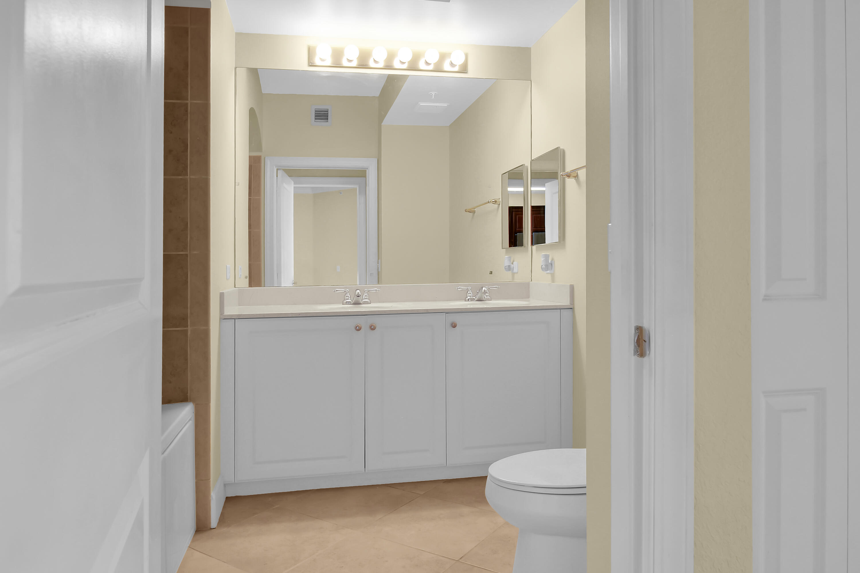 1690 Renaissance Commons Boulevard Boynton Beach, FL 33426 - Photo 8 of 22 a bathroom with a toilet sink and mirror