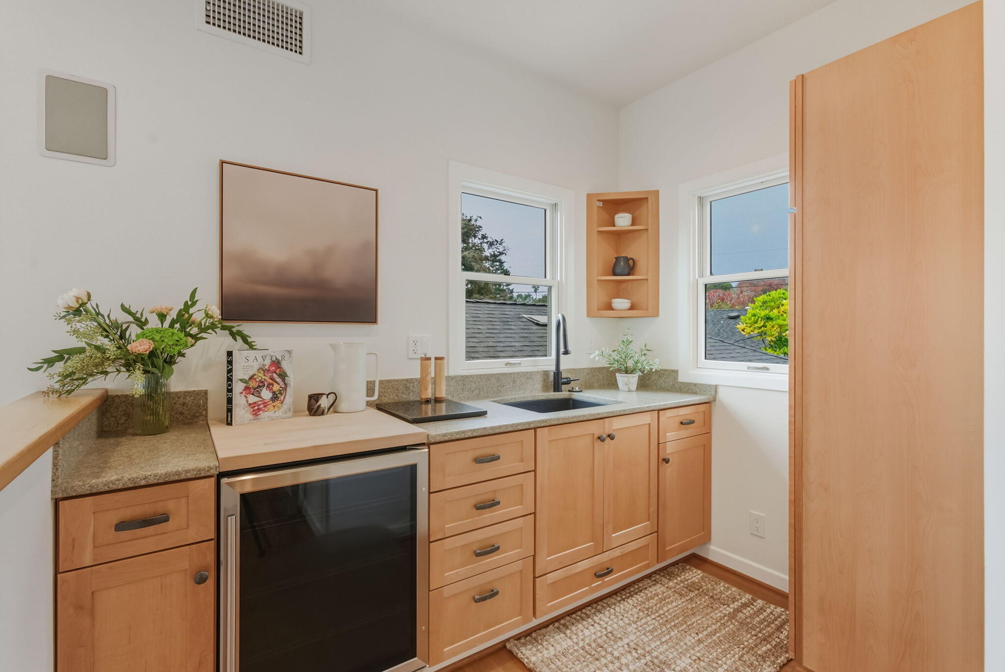 220 Santa Rosa Place Santa Barbara, CA 93109 - Photo 20 of 35 a kitchen with a granite countertop cabinets sink and wooden floor