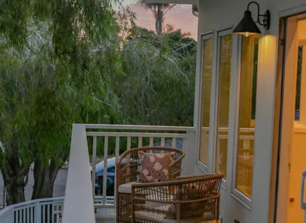 a view of balcony with wooden floor and fence