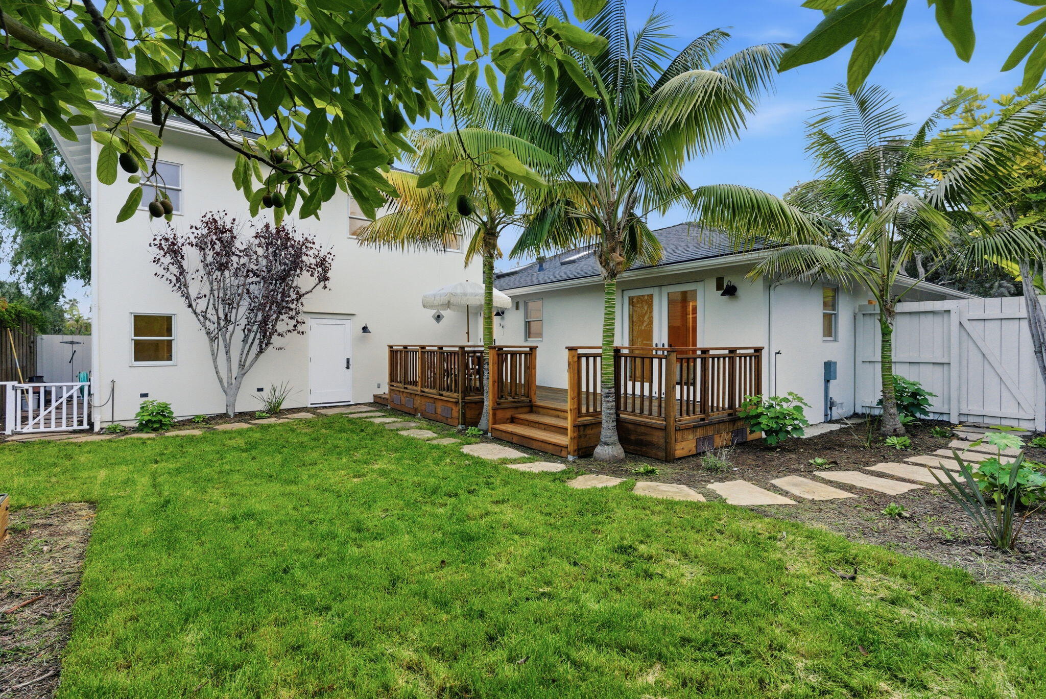 220 Santa Rosa Place Santa Barbara, CA 93109 - Photo 29 of 35 a view of a backyard with a table and chairs and a large tree