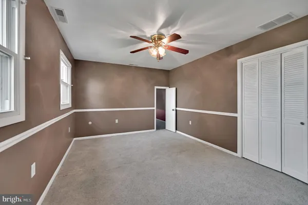 a view of a livingroom with a ceiling fan and window