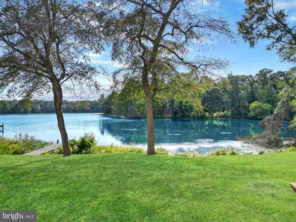 a view of a lake with outdoor space and mountain in the back