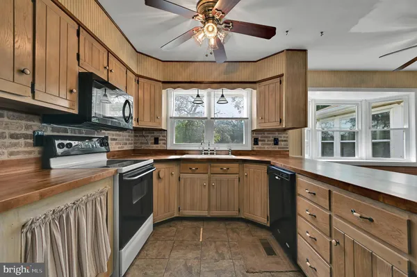 a kitchen with stainless steel appliances granite countertop a sink and cabinets