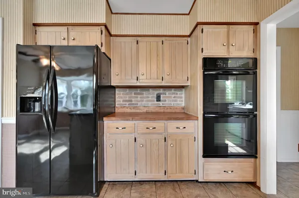 a kitchen with stainless steel appliances granite countertop a refrigerator and a stove
