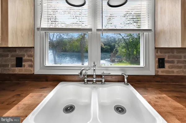 a bathroom with a granite countertop sink and a large window
