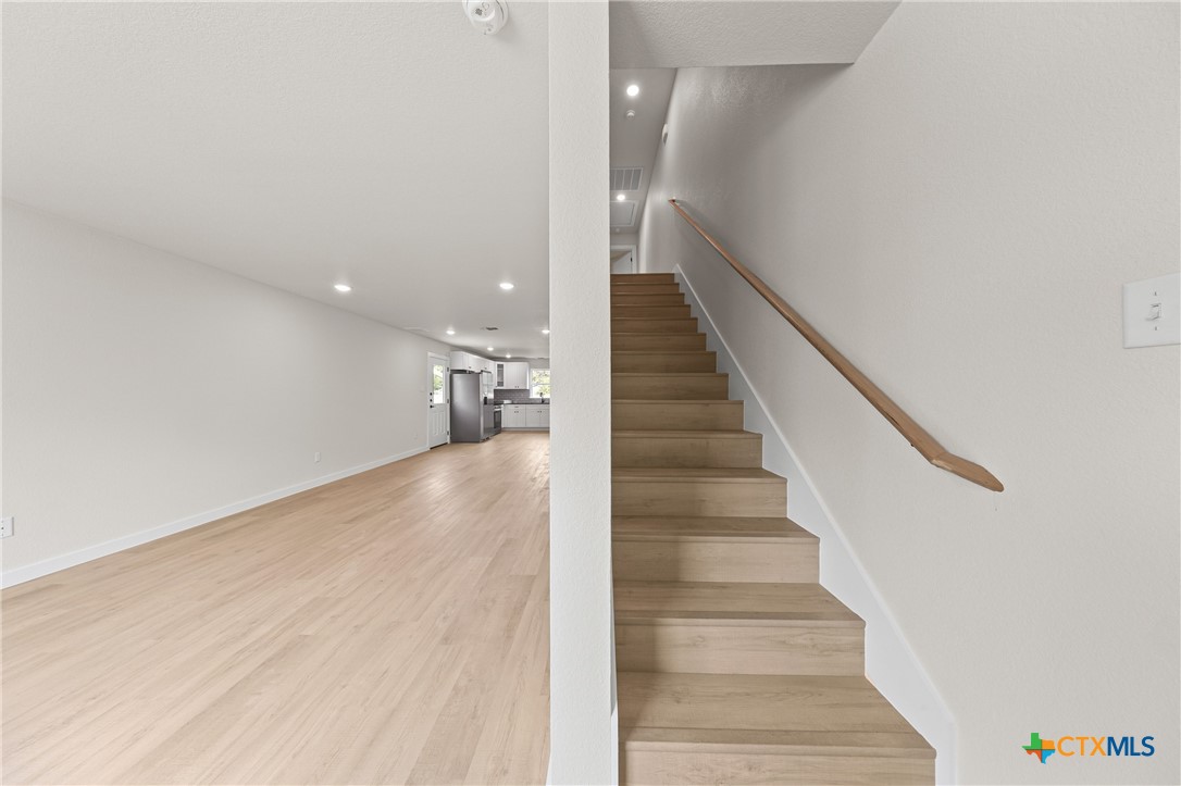 1204 Martin Luther King Jr Lane, Unit B Temple, TX 76504 - Photo 11 of 22 a view of staircase with white walls and white walls