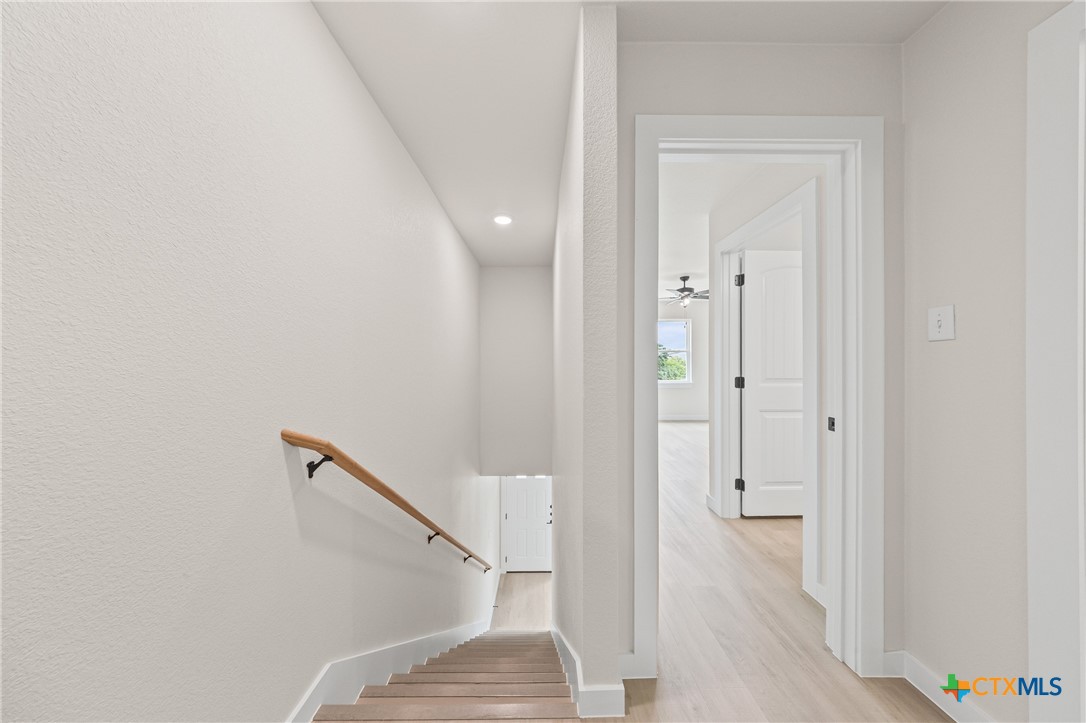 1204 Martin Luther King Jr Lane, Unit B Temple, TX 76504 - Photo 20 of 22 a view of a hallway with wooden floor and staircase