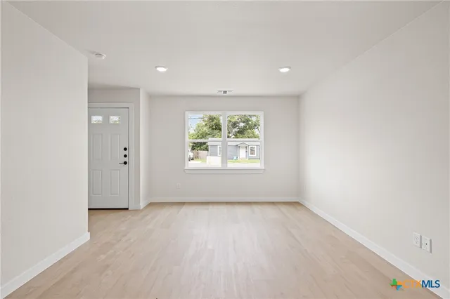 a large kitchen with cabinets and stainless steel appliances
