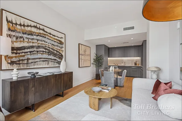 a living room with furniture and a painting on the wall