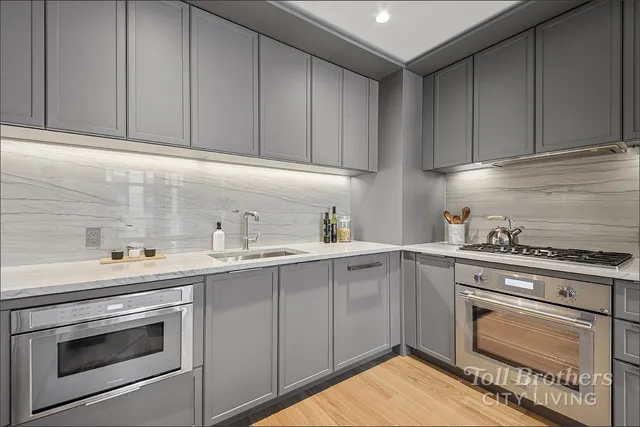 a kitchen with a sink cabinets and stainless steel appliances