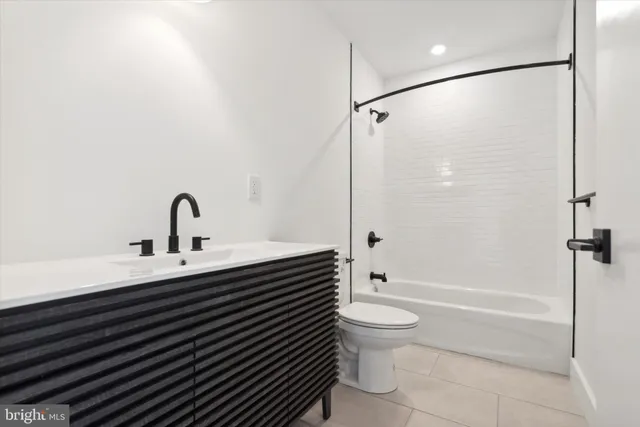 a bathroom with a sink a toilet and a shower