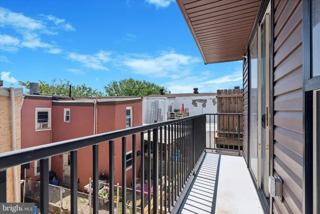 a view of a balcony with wooden floor and fence