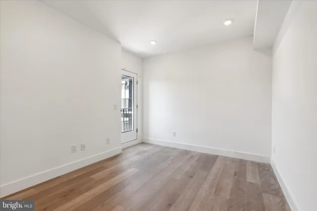 a view of room with wooden floor and window
