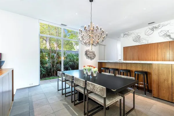 a view of a dining room with furniture and a chandelier