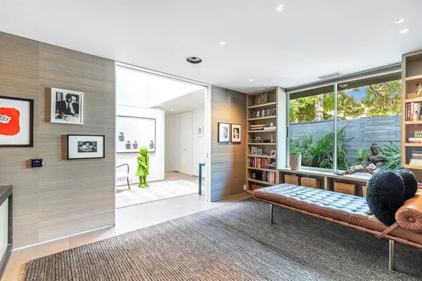 a living room with furniture and a wooden floor