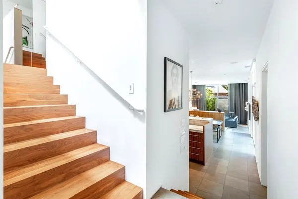 a view of entryway and hall with wooden floor