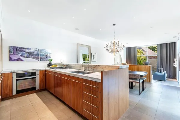 a kitchen with stainless steel appliances granite countertop a stove and a sink