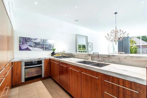 a kitchen with stainless steel appliances granite countertop a sink and stove