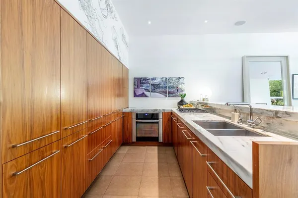 a kitchen with stainless steel appliances granite countertop a sink and stove top oven