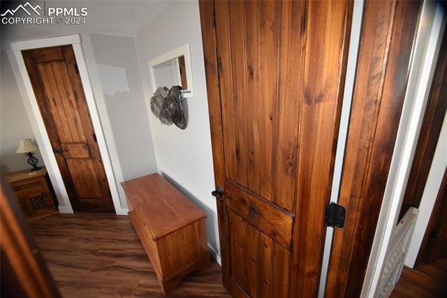 9990 Hahn Road Calhan, CO 80808 - Photo 12 of 25 Hallway with dark hardwood / wood-style flooring