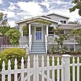 a front view of a house with a garden