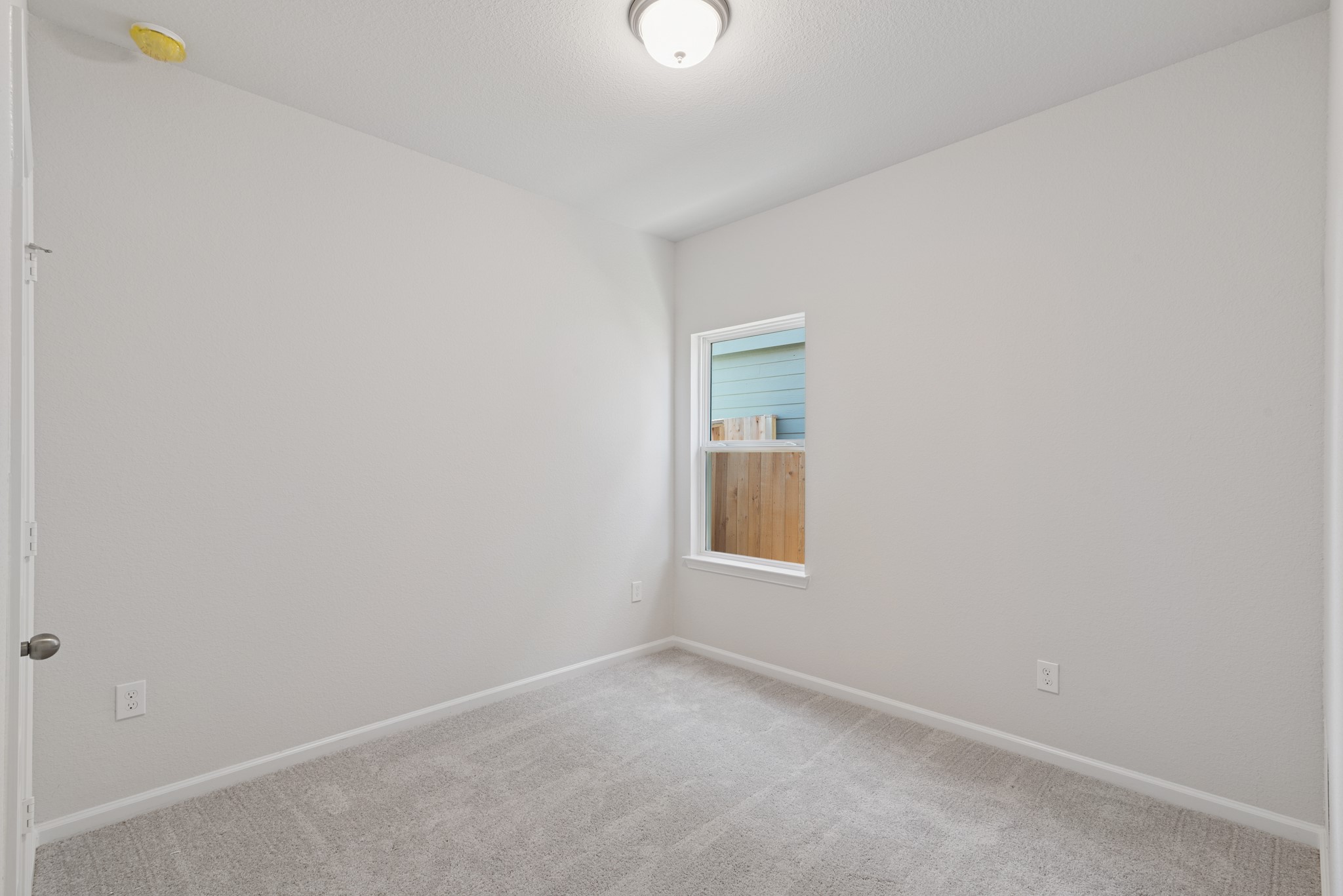 9793 Enclave Ridge Road Willis, TX 77318 - Photo 11 of 20 a view of an empty room with a window