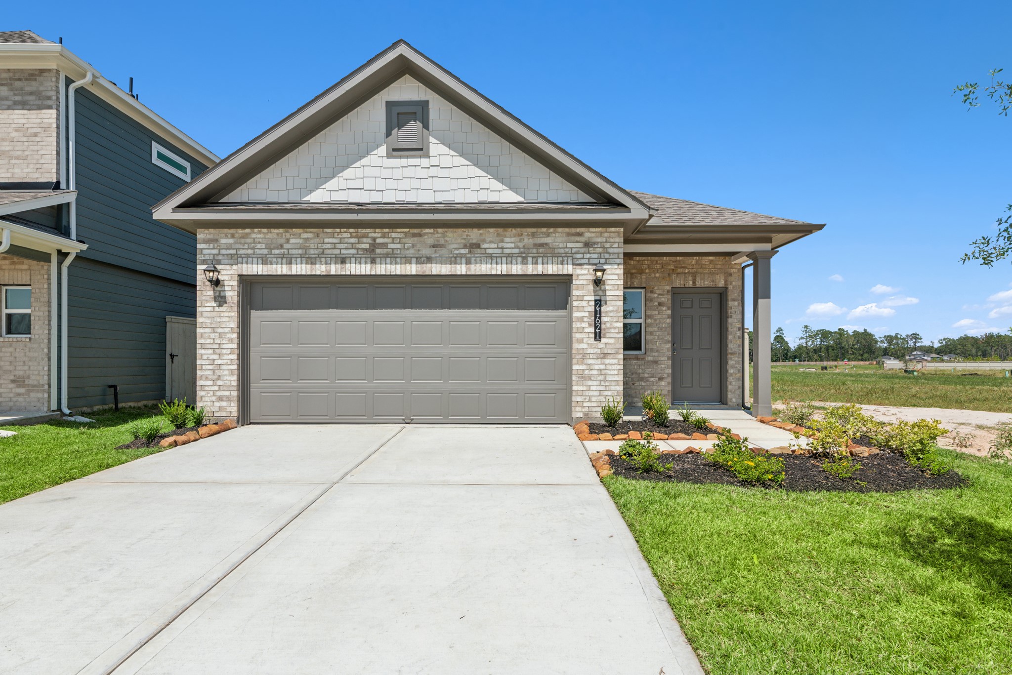 9793 Enclave Ridge Road Willis, TX 77318 - Photo 2 of 20 a front view of a house with garden