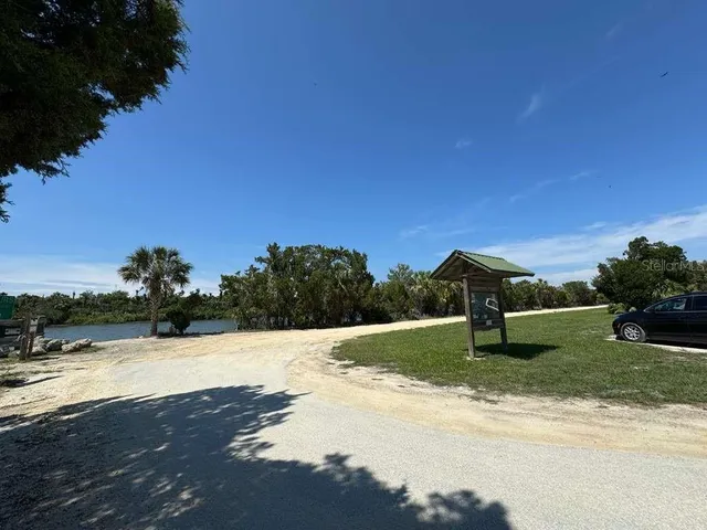 a view of yard with swimming pool and green space