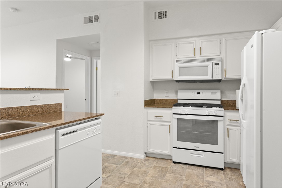 10550 West Alexander Road, Unit 1025 Las Vegas, NV 89129 - Photo 8 of 42 Functional kitchen with ample cabinetry and essential appliances.