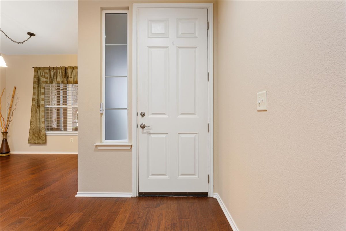 246 Red Poppy Trail Georgetown, TX 78633 - Photo 8 of 32 an empty room with wooden floor and windows
