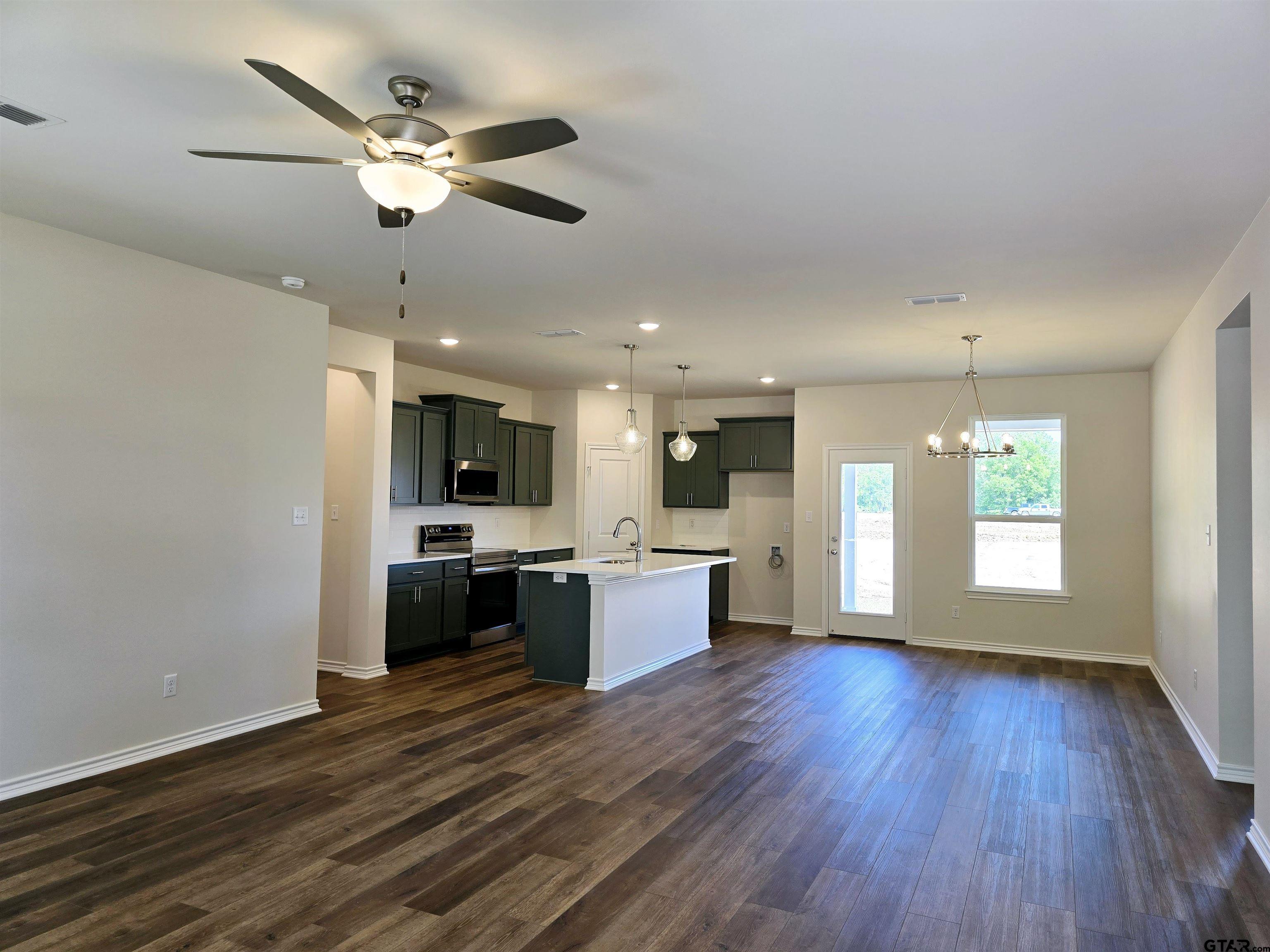 602 Kidd Drive Chandler, TX 75758 - Photo 4 of 22 a large kitchen with a wooden floor and stainless steel appliances