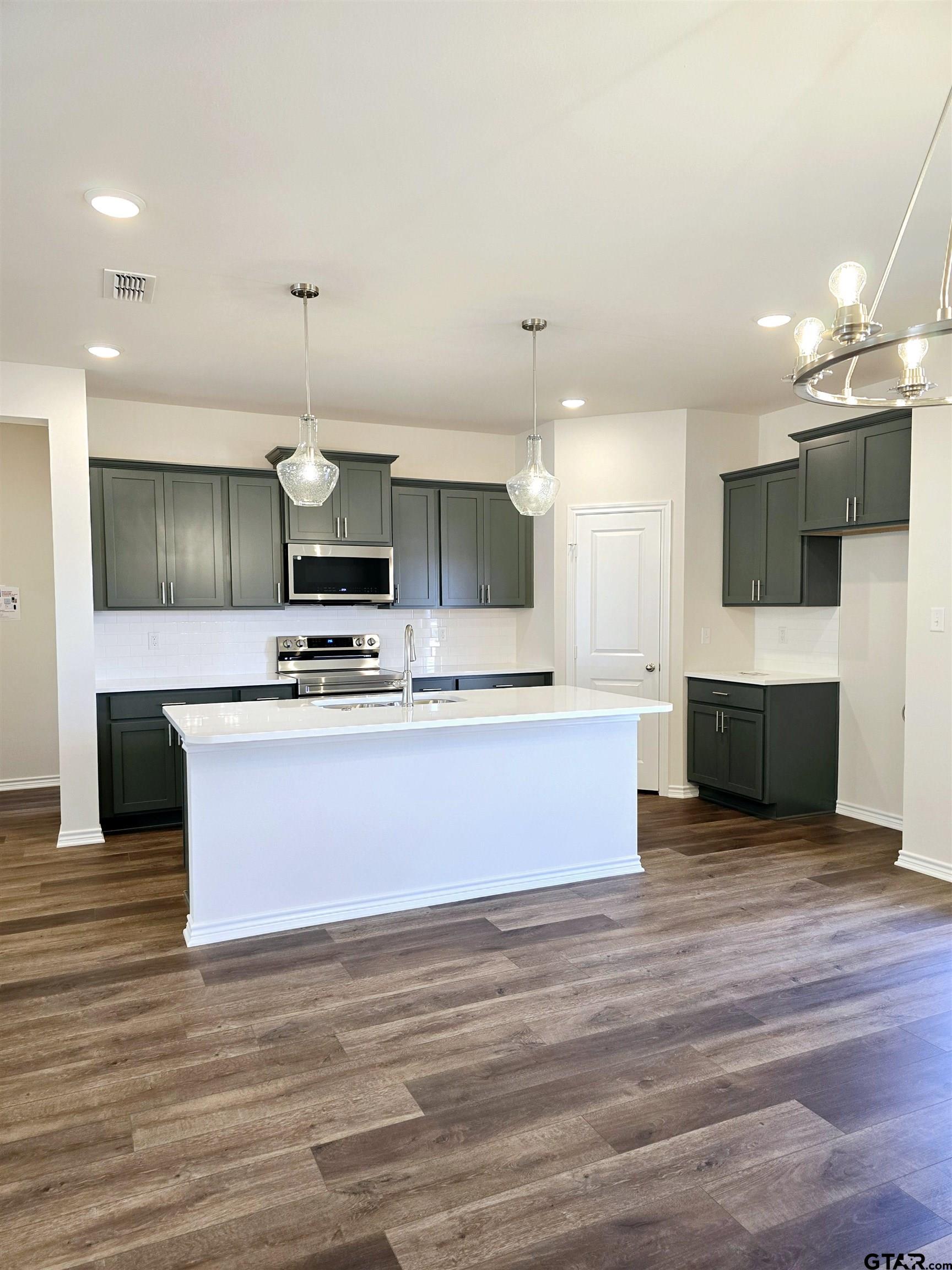 602 Kidd Drive Chandler, TX 75758 - Photo 5 of 22 a large kitchen with stainless steel appliances kitchen island a large counter top a sink and a stove