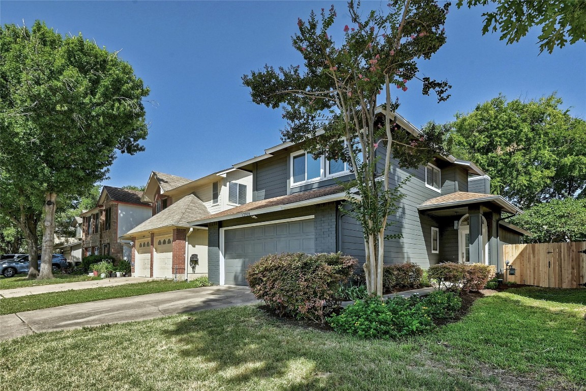 12904 Steeple-Chase Drive Austin, TX 78729 - Photo 1 of 1 front view of a house with a garden