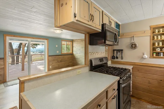 a kitchen with stainless steel appliances granite countertop a stove and a sink