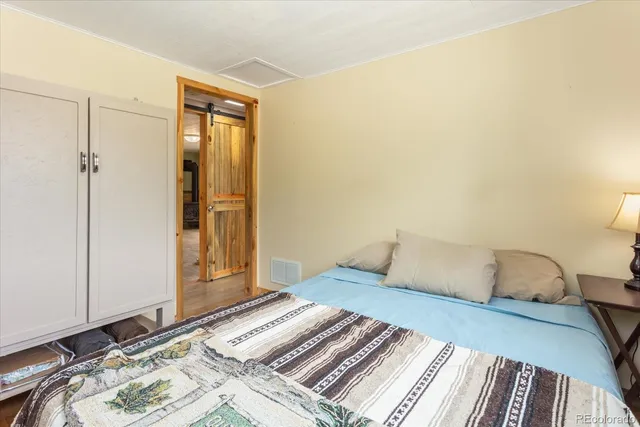 a bedroom with a bed and a mirror