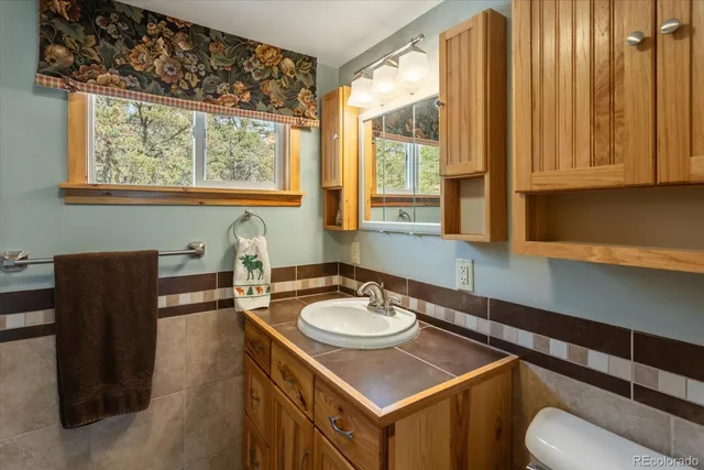 a bathroom with a sink a toilet and tub