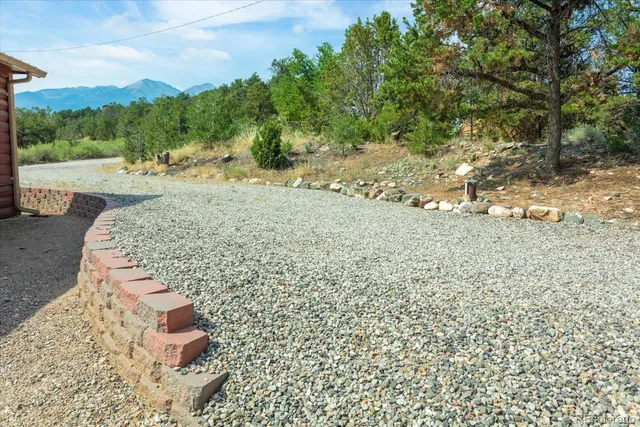 a kitchen with stainless steel appliances granite countertop a refrigerator a sink dishwasher and a stove with wooden floor