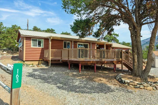 a view of a house with a yard and wooden fence