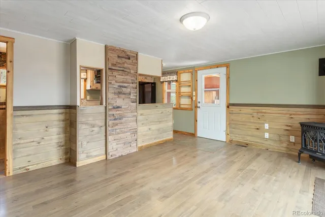 wooden floor in an empty room with a fireplace
