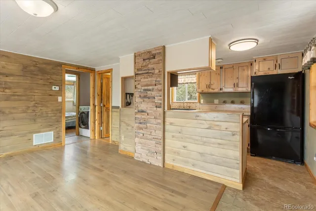 a kitchen with stainless steel appliances a refrigerator and cabinets