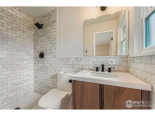 a bathroom with a sink toilet and mirror