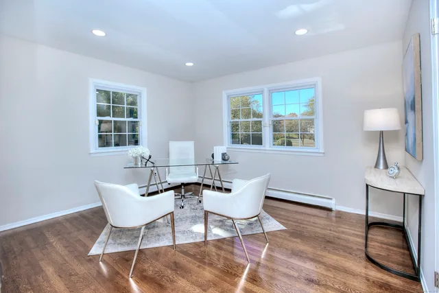 a dining room with furniture and wooden floor