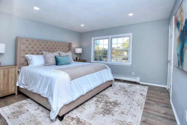 a bedroom with a bed and window